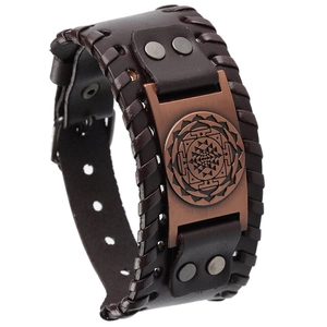 Detailed macro view of vintage brown leather bracelet with bronze mandala metal plate