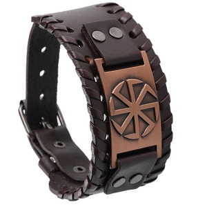 Detail of vintage brown leather bracelet featuring a bronze Kolovrat sun wheel plaque