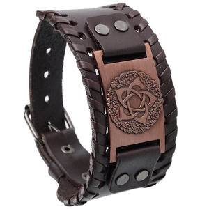 Detailed macro view of vintage brown leather bracelet with embossed copper metal plate