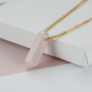 Minimalist gold-plated necklace featuring a hexagonal pink quartz column pendant