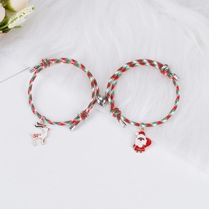 Gros plan du fermoir magnétique en cœur reliant les bracelets de Noël renne et Père Noël