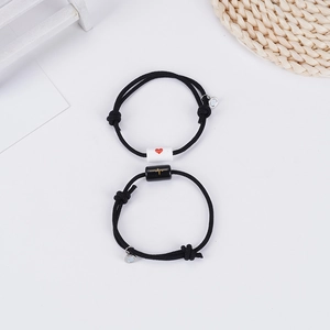 Matching couple bracelets with magnetic heart and EKG charms on adjustable black cords