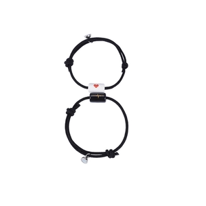 Detail of adjustable couple magnetic bracelets with heart and heartbeat pattern charms