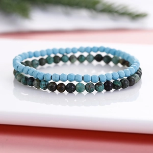6mm African turquoise and blue faceted bead bracelet set on a reflective white base