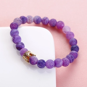 Detail of 8mm purple dragon agate beads and gold crown charm with micro-inlaid crystals