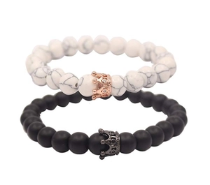 Close-up of 8mm beaded crown bracelets featuring white howlite and matte black agate beads