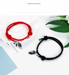 Detail of magnetic heart charms on adjustable woven rope bracelets for couples