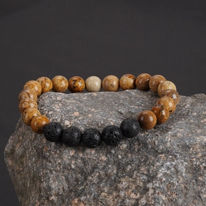 Bracelet de perles en jaspe paysage et pierre de lave noire sur support minéral naturel