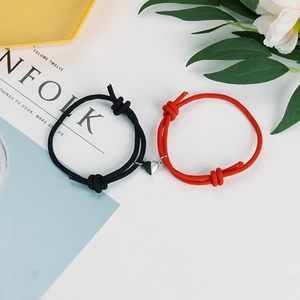 Detail of adjustable couple bracelets with magnetic heart charm on Kinfolk magazine