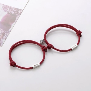 Detail view of red braided rope bracelet with heart magnet clasp and custom engraving