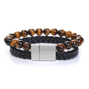 Dettaglio delle perle in occhio di tigre e bracciale in pelle intrecciata con fibbia magnetica