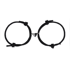 Detail of adjustable black woven magnetic heart couple bracelets with silver accents