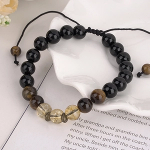 Adjustable braided bracelet with black obsidian beads and yellow tiger eye stones