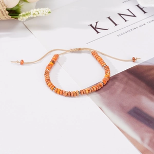 Bohemian adjustable beaded bracelet with orange disc beads and khaki woven cord string