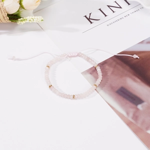 Pink natural stone beaded bracelet with gold spacers and adjustable cord tie