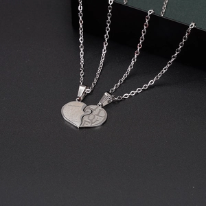 Detailed macro shot of a puzzle heart pendant set in titanium steel with Love engraving