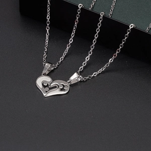 Detailed macro view of heart puzzle necklace with I Love You engraved on polished steel