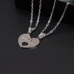 Detailed macro of polished stainless steel puzzle heart necklace with Best Friend engraving