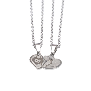 Detailed close-up of polished stainless steel heart pendant necklace with engraved vows