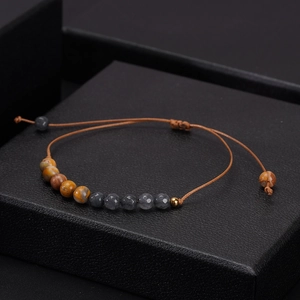 Detail view of 6mm woven beaded bracelet with natural stone and adjustable cord