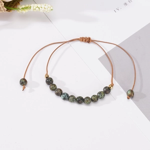 Handmade woven natural stone bead bracelet with adjustable cord and vintage aesthetic