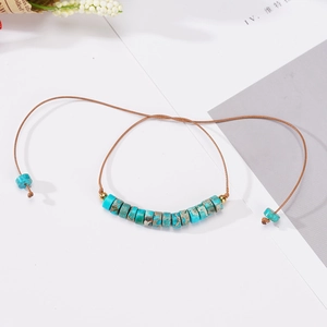 Adjustable hand-woven 6mm turquoise cylinder bead bracelet with gold metal accents