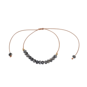 Detail of 6mm faceted natural grey stone beaded bracelet with adjustable woven cord