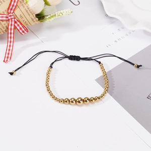 Adjustable black woven rope bracelet with gradient golden stainless steel beads