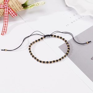 Adjustable hand-woven stainless steel beaded bracelet in black and gold finish