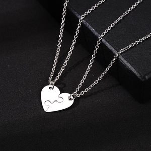 Polished titanium steel puzzle heart necklace set for couples on black background