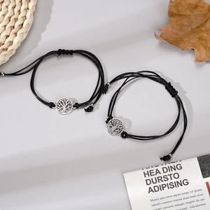 Detail view of adjustable black cord bracelets with silver Tree of Life metal pendants