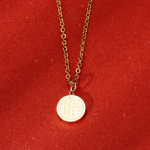 18K gold plated titanium steel necklace with a round Fu character pendant on red silk