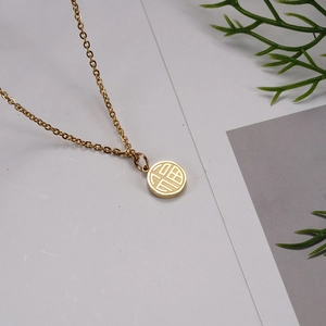 Detailed view of 18K gold plated stainless steel round pendant with Fu character engraving