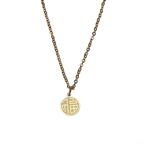 Detailed close-up of 18K gold plated titanium necklace featuring round Fu character pendant