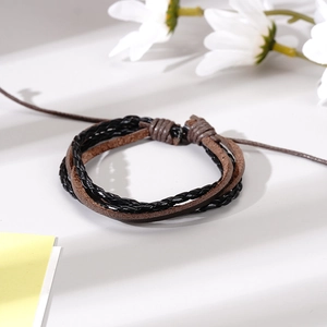 Détail du bracelet en cuir tressé multicouche fait main avec motif de feuille rétro