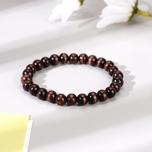 Men's handcrafted brown wooden bead bracelet with natural grain on white background