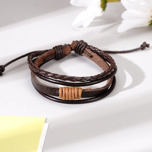 Detail of woven leather bracelet with vintage multi-layer design and adjustable cord