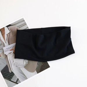Detail view of black wide elastic headband with matte fabric texture on white background