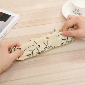 Close-up of flexible daisy print fabric hair scrunchie showing high elasticity and soft texture