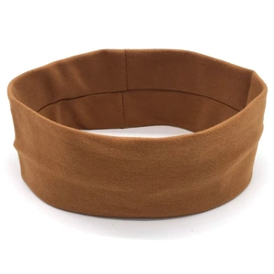 Detailed close-up of the caramel brown elastic knit yoga headband with stitching details