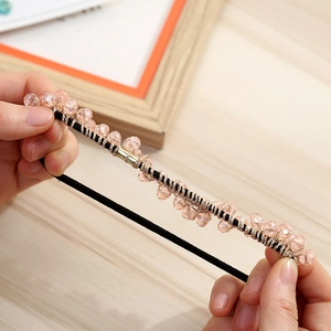 Detail of hand-woven beaded hair tie with pink crystals and high-elastic rubber band