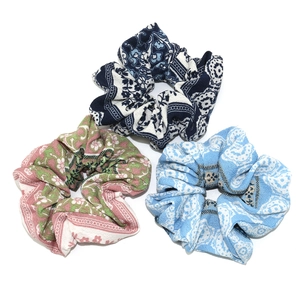 Set of 3 floral fabric scrunchies in ethnic, flower, and wavy patterns for hair styling