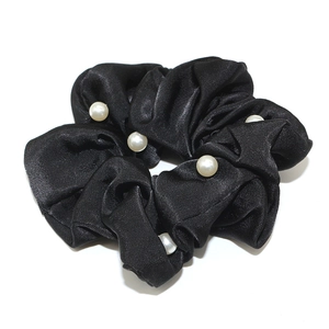 Elegant black satin scrunchie for women with five white pearl accents on white background