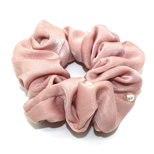 Pink satin scrunchie with elegant faux pearl embellishments and ruffled fabric design
