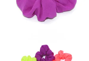 Close-up of assorted fluorescent scrunchies with pleated matte fabric texture