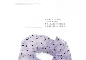 Detail of lavender sheer mesh scrunchie with black polka dots and fine shimmer texture