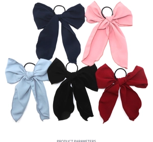 Detail of five assorted chiffon bow scrunchies with long ribbons in vibrant colors