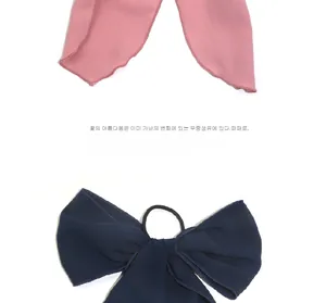 Detail of pink and navy blue ribbon bow hair ties made of soft chiffon fabric