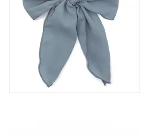 Detailed view of the fine stitched edges and soft fabric texture of the grey-blue bow scrunchie