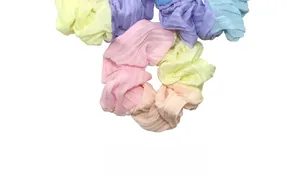Macro shot of colorful pleated chiffon hair scrunchies in pastel candy tones